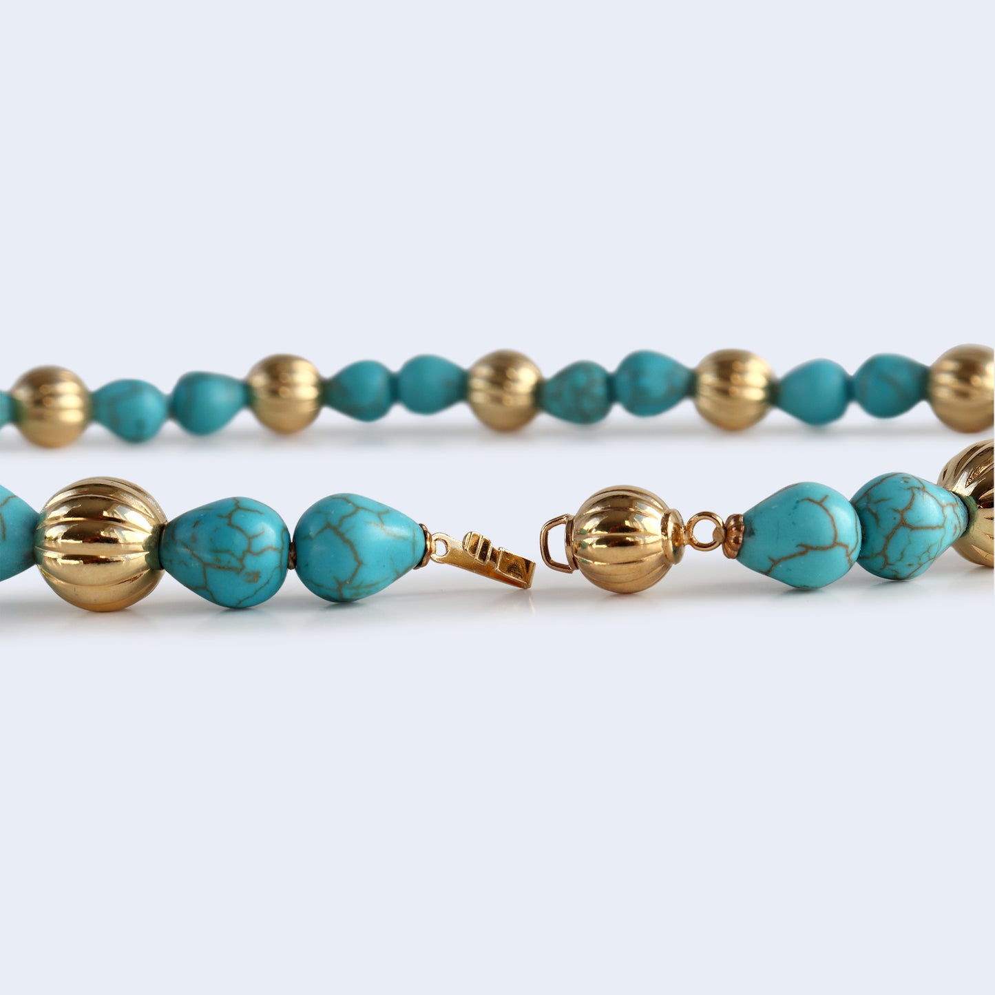 Silk thread, beaded gemstone necklace with golden beads.