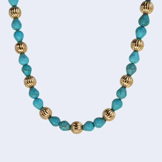 Gemstone necklace with gold plated beads.